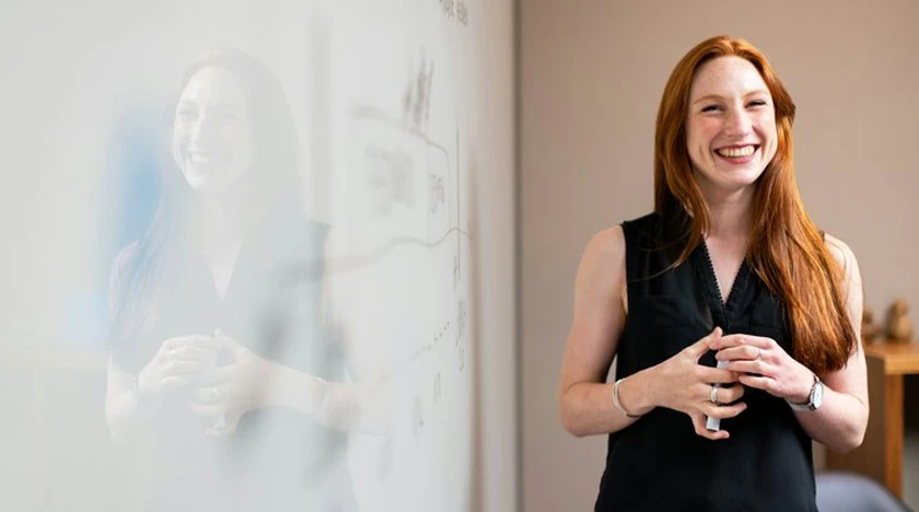 International school advisor standing in front of a whiteboard.