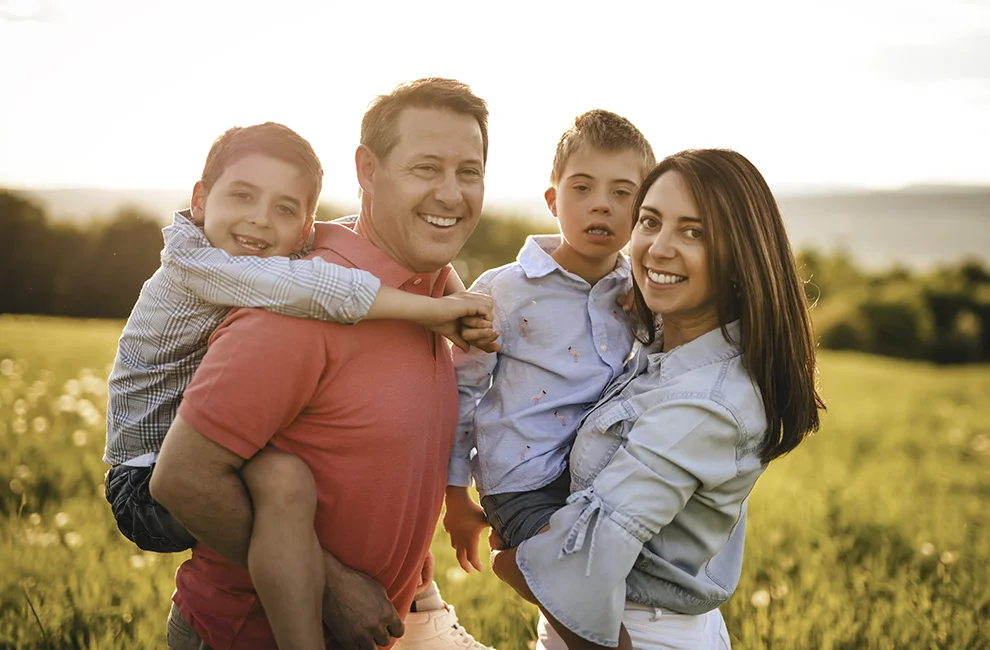 Smiling expat family with a child who has a developmental disability.
